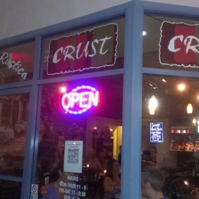 Photo taken at Crust Pizzeria and Ristorante by Karie C. on 7/21/2012