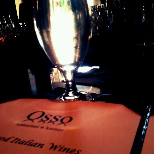 Photo taken at Osso Restaurant and Lounge by Ashley J. on 6/21/2012