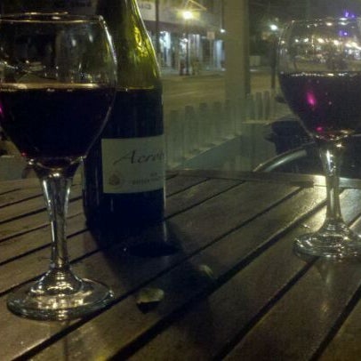 Photo taken at Grand Vin Wine Shop &amp; Bar by Jenny R. on 3/25/2012