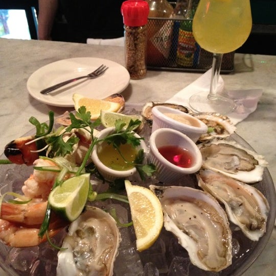 Photo taken at East Coast Grill &amp; Raw Bar by Jenny C. on 3/31/2012