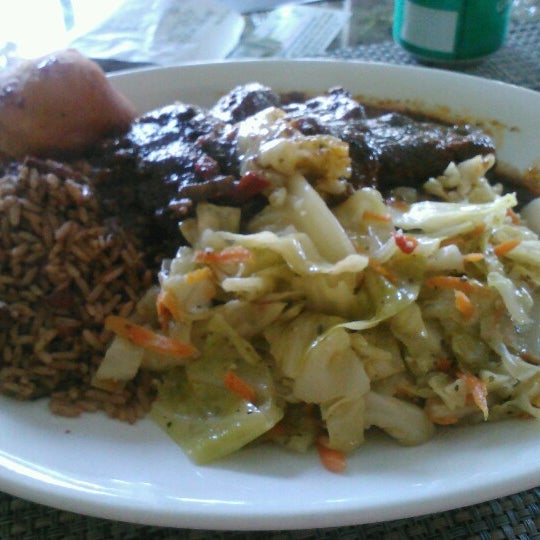 Photo taken at Ackee Bamboo Jamaican Cuisine by Daniealle B. on 6/16/2012
