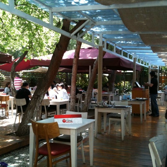 Photo taken at Time Café &amp; Restaurant by Muge M. on 5/2/2012