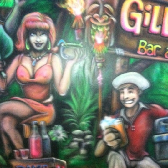 Photo taken at Gilligan&#39;s Tropical Bar &amp; Grill by Chris F. on 3/8/2012
