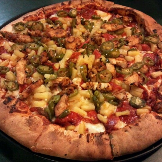 Photo taken at Woodstock&#39;s Pizza by Henry C. on 9/4/2012