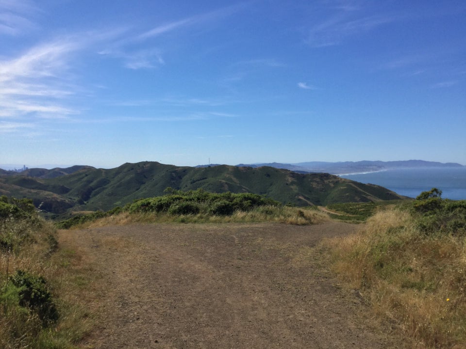 Coastal trail forking into Fox and Coastal trails, Marin Headlands in the background, with a bit of downtown San Francisco peeking above, and Sutra tower just left of center