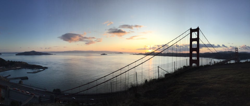 Panoramic photograph of sunrise over San Francisco and the bay, from Angel Island to Alcatraz to the city skyline, Golden Gate Bridge, and Sutro tower in the distance