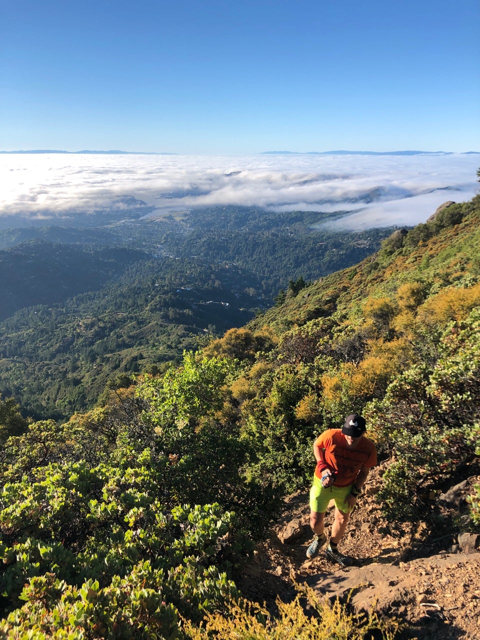 Tantek climbing up Mt Tam with hills, the bay, clouds, in the background